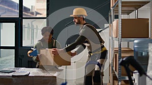 Warehouse trainee seals cardboard boxes