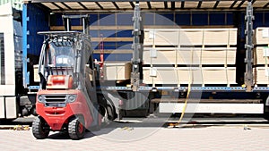 Warehouse. unloading of the truck. Unloading goods from the truck to the warehouse. Forklift is putting cargo from truck