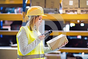 Warehouse woman worker with barcode scanner. photo