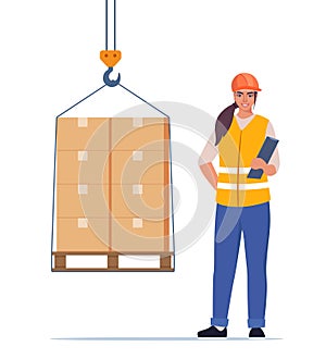 Warehouse worker. Boxes on a pallet are lifted with a crane hook. Warehouse female worker in hard hat manages the loading process