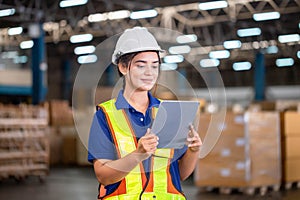 Warehouse worker with digital tablet checking inventory in warehouse, Female warehouse worker working in factory warehouse