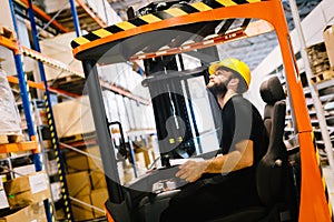 Warehouse worker doing logistics work with forklift loader