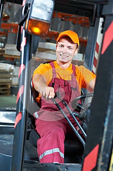 Warehouse worker driver in forklift