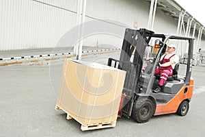 Warehouse worker driver in forklift