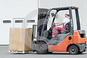 Warehouse worker driver in forklift