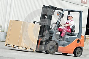 Warehouse worker driver in forklift