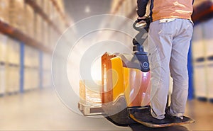 Warehouse Worker Driving Electric Forklift Pallet jack Unloading Package Boxes. Shipment. Storage Warehouse Tall Shelves.
