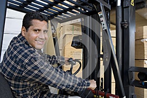 Warehouse Worker Driving Forklift