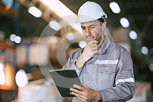 Warehouse worker, Engineer manager looking at tablet screen with thinking have a problem expression