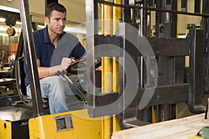 Warehouse worker in forklift