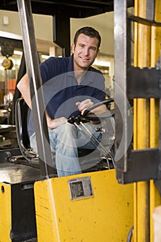 Warehouse worker in forklift