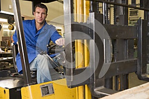 Warehouse worker in forklift