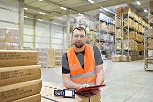 warehouse worker in a forwarding agency - interior with forklift - transport and storage of goods