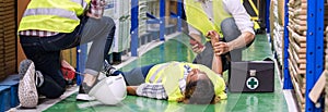 Warehouse worker frist aid after accident panoramic