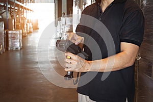 Warehouse Worker Holding Bar Code Scanner His Doing Check Stock at Storage Warehouse. Computer Work Tools for Warehouse Inventory.