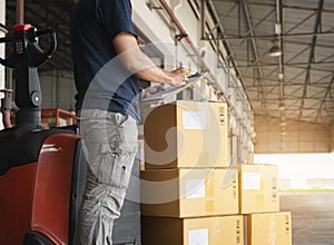 Warehouse Worker Holding Clipboard Doing Inventory Management Package Boxes. Check Stock. Shipment Boxes.