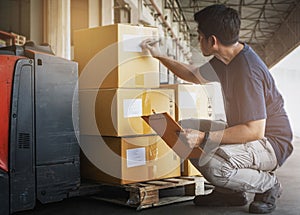 Warehouse worker holding clipboard his doing inventory management package boxes. Checking stock, Warehousing. Cargo shipment boxes