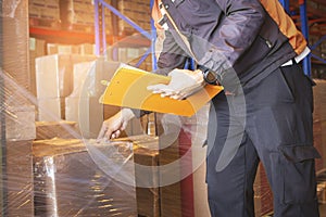 Warehouse Worker Holding Clipboard His Doing Inventory Management at Storage Warehouse. Check Stock Package Boxes