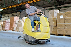 warehouse worker loading construction materials with forklift