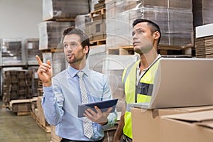 Warehouse worker and manager working together