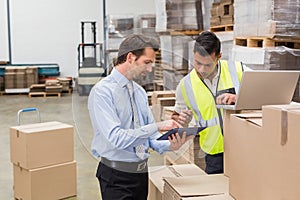 Warehouse worker and manager working together