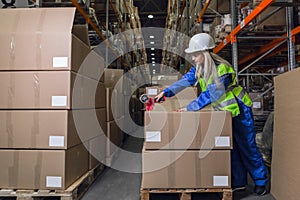 Warehouse worker packing boxes in storehouse photo