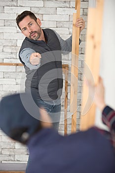 warehouse worker pointing with finger at doors