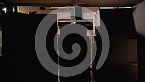 Warehouse worker putting package in the shelf full of parcels in a warehouse