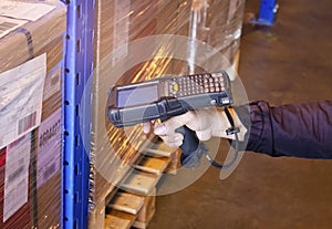 Warehouse Worker Scanning Bar Code Scanner with Wooden Box. Computer Tools for Warehouse Inventory Management.