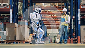 Warehouse worker is stocktaking boxes driven by a human-like robot