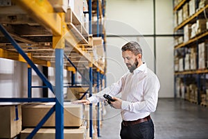 Warehouse worker or supervisor with barcode scanner. photo
