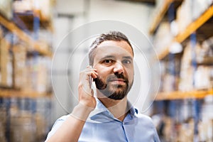 Warehouse worker or supervisor with a smartphone.