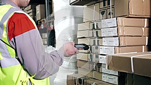 A warehouse worker uses a barcode scanner