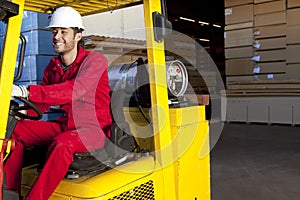 Warehouse worker using forklift truck