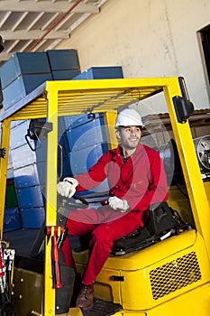 Warehouse worker using forklift truck