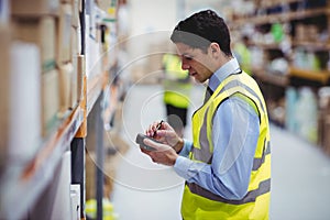 Warehouse worker using hand scanner