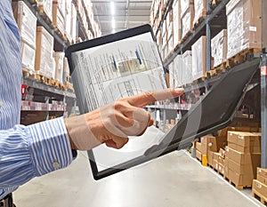 Warehouse Worker Using Tablet for Inventory Management