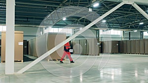 Warehouse worker is walking along the refrigeration factory