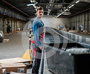 Warehouse worker working on a conveyor line