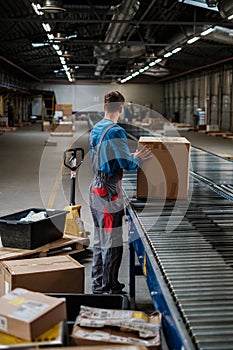 Warehouse worker working on a conveyor line