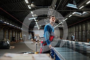 Warehouse worker working on a conveyor line photo