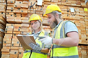 Warehouse workers checking inventory in a large distrubiton warehouse.