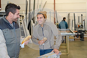 warehouse workers eating sandwiches during lunchbreak