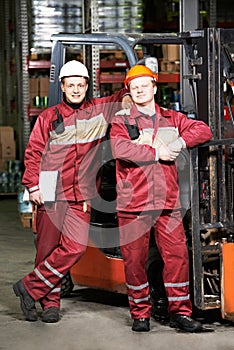 Warehouse workers in front of forklift