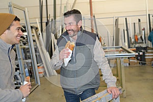 Warehouse workers having lunch break photo