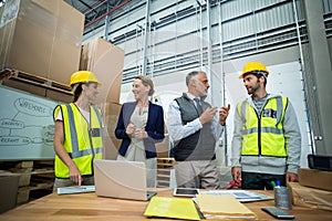 Warehouse workers and managers interacting with each other