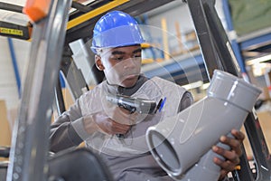 Warehouseman with protective vest and scanner photo