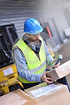 Warehouseman scanning delivered goods photo