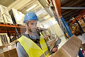 Warehouseman scanning products photo