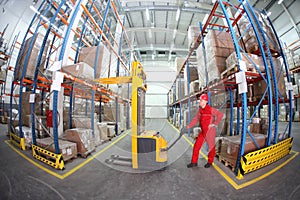 warehousing - Manual forklift operator at work in